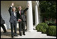 President George W. Bush and Prime Minister Junichiro Koizumi of Japan wave from the steps of the Rose Garden before meeting in the Oval Office Thursday, June 29, 2006 White House photo by Eric Draper