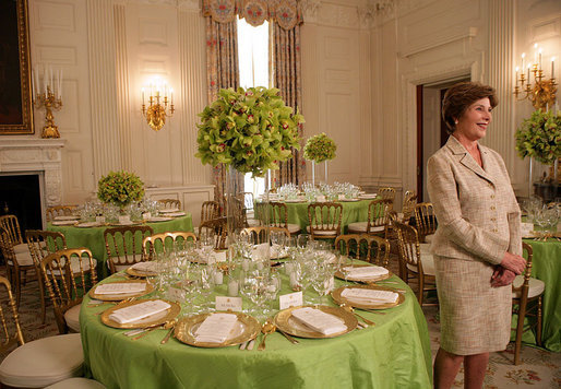 Mrs. Laura Bush discusses the motifs and entertainment for the official dinner honoring His Excellency Junichiro Koizumi, Prime Minister of Japan, in the State Dining Room during a media preview Thursday, June 29, 2006. "I think it's going to be a very fun evening," said Mrs. Bush. "Our orchestra is the Brian Setzer Orchestra. He'll play a lot of both the President's and Prime Minister Koizumi's favorites, and he's especially known for his guitar. So I think that will be terrific." White House photo by Shealah Craighead