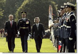President George W. Bush and Prime Minister Junichiro Koizumi of Japan review the troops during an arrival ceremony on the South Lawn Thursday, June 29, 2006. "Japan is now the third largest donor nation for reconstruction efforts in Afghanistan," said President Bush in his address. "In Iraq, Japanese self-defense forces have helped improve the lives of citizens in a key Iraqi province that will soon return to Iraqi control." White House photo by Paul Morse