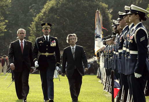 President George W. Bush and Prime Minister Junichiro Koizumi of Japan review the troops during an arrival ceremony on the South Lawn Thursday, June 29, 2006. "Japan is now the third largest donor nation for reconstruction efforts in Afghanistan," said President Bush in his address. "In Iraq, Japanese self-defense forces have helped improve the lives of citizens in a key Iraqi province that will soon return to Iraqi control." White House photo by Paul Morse