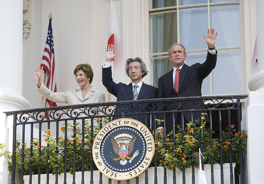 President George W. Bush, Laura Bush and Prime Minister Junichiro Koizumi of Japan wave from the South Portico Balcony at the conclusion of the official arrival ceremony Thursday, June 29, 2006. White House photo by Eric Draper