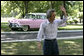 Japan's Prime Minister Junichiro Koizumi stands before a classic pink Cadillac and waves to reporters as he wears a pair of Elvis Presley style sunglasses during his tour Friday, June 30, 2006 of Presley's mansion, Graceland, with President George W. Bush and Mrs. Laura Bush in Memphis. White House photo by Eric Draper