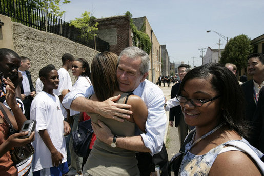 President George W. Bush embraces a young woman and meets other visitors outside the National Civil Rights Museum, Friday, June 30, 2006 in Memphis, where President Bush was joined by Mrs. Laura Bush and Japan's Prime Minister Junichiro Koizumi on a tour of the site where civil rights leader Dr. Martin Luther King, Jr. was assassinated in 1968. White House photo by Eric Draper