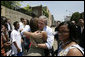 President George W. Bush embraces a young woman and meets other visitors outside the National Civil Rights Museum, Friday, June 30, 2006 in Memphis, where President Bush was joined by Mrs. Laura Bush and Japan's Prime Minister Junichiro Koizumi on a tour of the site where civil rights leader Dr. Martin Luther King, Jr. was assassinated in 1968. White House photo by Eric Draper