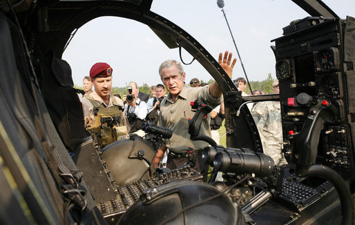 President George W. Bush is shown a helicopter Tuesday, July 4, 2006, during his Independence Day visit to Fort Bragg in North Carolina, where he addressed troops and met with the U.S. Army Special Operations Command. White House photo by Paul Morse
