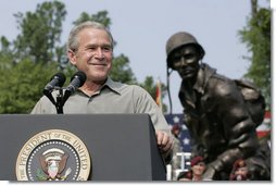 President George W. Bush reacts to applause during his remarks to U.S. troops and their family members Tuesday, July 4, 2006, during an Independence Day celebration at Fort Bragg in North Carolina. President Bush thanked the troops and their families for their service to the nation.  White House photo by Paul Morse