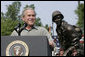 President George W. Bush reacts to applause during his remarks to U.S. troops and their family members Tuesday, July 4, 2006, during an Independence Day celebration at Fort Bragg in North Carolina. President Bush thanked the troops and their families for their service to the nation. White House photo by Paul Morse