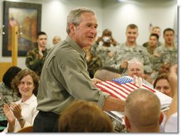 President George W. Bush is presented with a birthday cake in honor of his upcoming 60th birthday, at a luncheon with troops Tuesday, July 4, 2006, at Fort Bragg in North Carolina. President Bush earlier addressed the troops at an Independence Day celebration thanking them for their service to the nation.  White House photo by Paul Morse