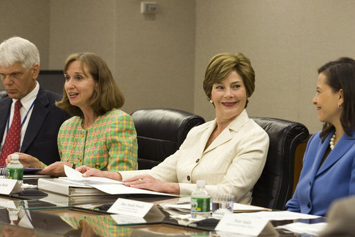 Mrs. Laura Bush smiles at Dina Hibab Powell, Deputy Under Secretary for Public Diplomacy, Public Affairs and Assistant Secretary of State for Educational and Cultural Affairs during the fifth meeting of the U.S. Afghan Women's Council at the State Department, Wednesday, July 5, 2006, in Washington, D.C. Also shown are Dr. Paula Dobrianksy, Under Secretary of State for Democracy and Global Affairs, left, and James Kunder, Assistant Administrator for Asia and the Near East, USAID. White House photo by Shealah Craighead