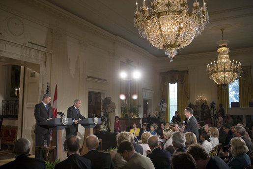 President George W. Bush and Canadian Prime Minister Stephen Harper talk with the media during a joint press conference in the East Room Thursday, July 6, 2006. "We've had some disputes in the past, trade disputes. That's what you expect when you have a lot of trade," said President Bush. "And probably the most nettlesome trade dispute was softwood lumber. And I appreciate the Prime Minister's leadership in helping us resolve this issue." 
