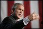 President George W. Bush gestures as he addresses a news conference at the Museum of Science and Industry in Chicago, Friday, July 7, 2006, speaking on the economy, immigration reform and security issues. White House photo by Eric Draper