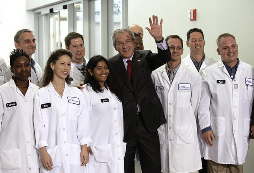 President George W. Bush stands with a group of employees as he waves to others during a tour of the Cabot Microelectronics Corporation facility in Aurora, Ill., Friday, July 7, 2006. White House photo by Eric Draper