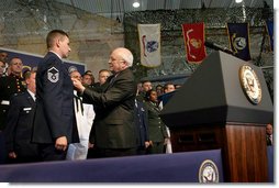 Vice President Dick Cheney pins the Purple Heart Medal onto Master Sergeant Henry G. Christle, Jr., Monday, July 10, 2006, during a rally for the Michigan National Guard and Joint Services at Selfridge Air National Guard Base in Harrison Township, Mich. Master Sergeant Christle was wounded in action on March 23, 2004 while serving as a Special Operations Weather Team Forecaster and Observer assigned to the Combined Joint Special Operations Task Force 180, Afghanistan.  White House photo by David Bohrer