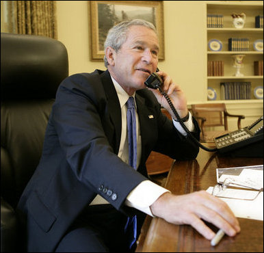 President George W. Bush speaks with crew members of the Space Shuttle Discovery during a telephone call from the Oval Office of the White House Tuesday, July 11, 2006. White House photo by Eric Draper