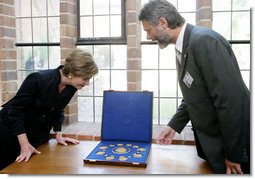 Mrs. Laura Bush is shown jewelry artifacts on her tour of the City of Stralsund Archives in Stralsund, Germany, Thursday, July 13, 2006, by Dr. Andreas Gruger, director of the Stralsund Museum of Cultural History. White House photo by Shealah Craighead