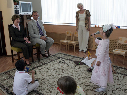 During a tour of the Pediatric HIV/AIDS Clinic Center of Russia, Mrs. Laura Bush and Dr. Evgeny Voronin listen to Gayla, a patient, perform in the Music Room Friday, July 14, 2006, in St. Petersburg, Russia. Music instructor Valentina Leontieva looks on. White House photo by Shealah Craighead
