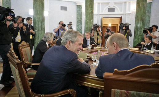 President George W. Bush talks with Russian President Vladimir Putin during a working session at the G8 Summit in Strelna, Russia, Sunday, July 16, 2006. White House photo by Eric Draper