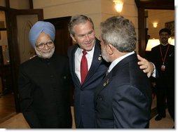 President George W. Bush embraces India’s Prime Minister Dr. Manmohan Singh, left, and Brazilian President Luiz Inacio Lula da Silva, right, at the Konstantinovsky Palace Complex Monday, July 17, 2006. President Bush met with the two leaders separately in bilateral meetings during the G8 Summit in Strelna, Russia.  White House photo by Eric Draper
