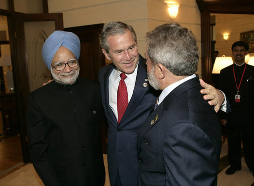 President George W. Bush embraces India’s Prime Minister Dr. Manmohan Singh, left, and Brazilian President Luiz Inacio Lula da Silva, right, at the Konstantinovsky Palace Complex Monday, July 17, 2006. President Bush met with the two leaders separately in bilateral meetings during the G8 Summit in Strelna, Russia. White House photo by Eric Draper