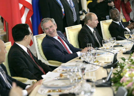 President George W. Bush talks with Chinese President Hu Jintao, left, during a luncheon with world leaders during the G8 Summit at the Konstantinovsky Palace Complex Monday, July 17, 2006 in Strelna, Russia. Also pictured is Russian President Vladimir Putin, and South African President Thabo Mbeki, far-right. White House photo by Eric Draper
