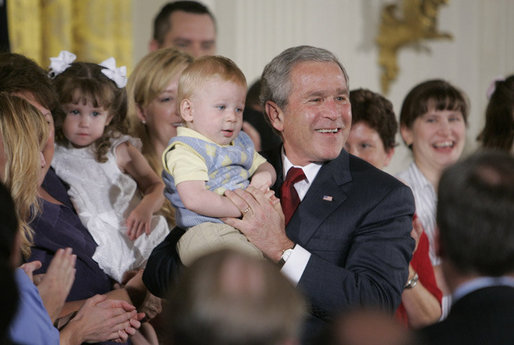 President George W. Bush holds 14-month-old Trey Jones of Cypress, Texas, following his remarks about stem cell research policy legislation in the East Room of the White House Wednesday, July 19, 2006. "Each of these children was adopted while still an embryo, and has been blessed with the chance to grow up in a loving family," said the President of children sharing the stage with him. "These boys and girls are not spare parts. They remind us of what is lost when embryos are destroyed in the name of research." Trey Jones was first introduced to the President during a White House visit in May 2005. White House photo by Kimberlee Hewitt