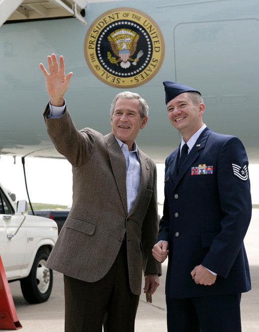 President George W. Bush meets with U.S. Air Force Tech. Sgt. Brian Webster next to Air Force One Friday, July 21, 2006, where he honored Webster with the President’s Volunteer Service Award at Buckley Air Force Base in Aurora, Colo. Tech. Sgt. Webster is co-founder and treasurer of the Hearts Across the Miles, a non-profit organization to providedeployed military personnel with care packages and thank you letters. White House photo by Eric Draper