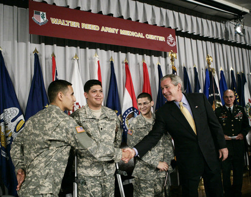 President George W. Bush shakes hands with newly sworn-in American citizens, Specialist Sergio Lopez, 24, of Bolingbrook, Ill., left, Specialist Noe Santos-Dilone of Brooklyn, N.Y., center, and Private First Class Eduardo Leal-Cardenas of Los Angeles, Calif., during their naturalization ceremony Monday, July 24, 2006, at Walter Reed Army Medical Center in Washington, D.C. White House photo by Eric Draper