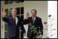 President George W. Bush and Iraqi Prime Minister Nouri al-Maliki walk along the colonnade of the Rose Garden after meeting in the Oval Office Tuesday, July 25, 2006. White House photo by Paul Morse