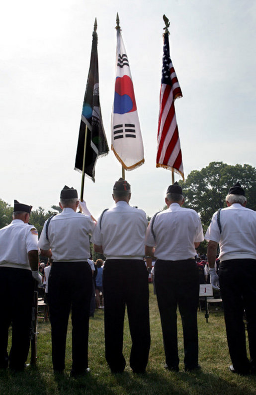 An honor guard composed of Korean War veterans holds flags prior to the start of the 2006 Korean War Veterans Armistice Day Ceremony held at the Korean War Memorial on the National Mall in Washington, D.C., Thursday, July 27, 2006. White House photo by David Bohrer