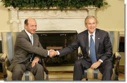President George W. Bush meets with Romanian President Traian Basescu in the Oval Office Thursday, July 27, 2006. "Romania will continue to remain an ally of the United States in supporting the democracy in Iraq and Afghanistan, in supporting democratic regimes in these countries like a key of freedom on the area," said President Basescu during the two leaders' remarks to the press.  White House photo by Eric Draper