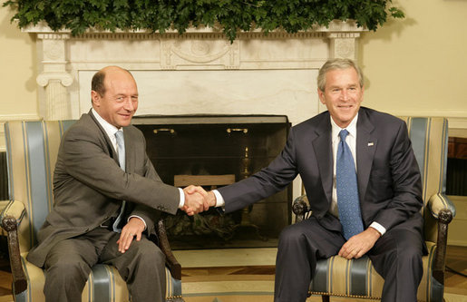 President George W. Bush meets with Romanian President Traian Basescu in the Oval Office Thursday, July 27, 2006. "Romania will continue to remain an ally of the United States in supporting the democracy in Iraq and Afghanistan, in supporting democratic regimes in these countries like a key of freedom on the area," said President Basescu during the two leaders' remarks to the press. White House photo by Eric Draper