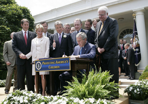 President George W. Bush is joined by Senate and House members as he signs H.R. 4472, the Adam Walsh Child Protection and Safety Act of 2006 at a ceremony Thursday, July 27, 2006, in the Rose Garden at the White House, as John Walsh, center, and his wife, Reve Walsh, look on. The bill is named for the Walsh’s six-year-old son Adam Walsh who was abducted and killed 25 years ago. White House photo by Eric Draper