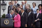 President George W. Bush talks with U.S. Representative Sheila Jackson Lee, D-Texas, during the signing of H.R. 9, the Fannie Lou Hamer, Rosa Parks, and Coretta Scott King Voting Rights Act Reauthorization and Amendments Act of 2006, on the South Lawn Thursday, July 27, 2006. White House photo by Paul Morse