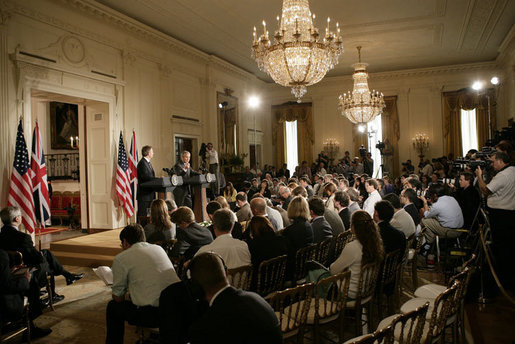 President George W. Bush is joined by Prime Minister Tony Blair of the United Kingdom as he answers a reporter’s question during a joint press availability Friday, July 28, 2006, in the East Room of the White House. White House photo by Eric Draper
