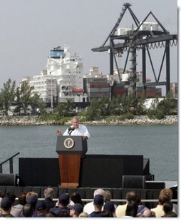 President George W. Bush addresses an audience on America's economy at the U.S. Coast Guard Integrated Support Command at the Port of Miami Monday, July 31, 2006. "It's an honor to be here at the largest container port in Florida and one of the most important ports in our nation," said President Bush. "From these docks, ships loaded with cargo deliver products all around the world carrying that label "Made in the USA."'  White House photo by Kimberlee Hewitt