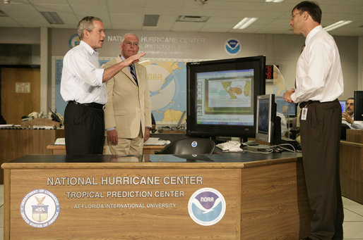 President George W. Bush talks with Max Mayfield, center, director of NOAA's Tropical Prediction Center and National Hurricane Center and with Chris Landsea the Science and Operations Officer at the National Hurricane Center in Miami Monday, July 31, 2006. White House photo by Kimberlee Hewitt