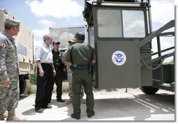 President George W. Bush speaks with members of the National Guard and U.S. Border Patrol officers during his tour along the U.S.-Mexico border Thursday, Aug. 3, 2006, in the Rio Grande Valley border patrol sector in Mission, Texas. White House photo by Eric Draper