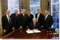 President George W. Bush prepares to sign H.R. 5683, to preserve the Mt. Soledad Veterans Memorial in San Diego, Calif., Monday, Aug. 14, 2006, at a signing ceremony in the Oval Office of the White House, which will provide for the immediate acquisition of the memorial by the United States. Joining President Bush at the signing, from left to right, Bill Kellogg, president of the Mount Soledad Association; Philip Thalheimer, chairman, San Diegans for Mt. Soledad National War Memorial; U.S. Rep. Brian Bilbray, R-Calif.; U.S. Rep. Darrell Issa, R-Calif.; U.S. Rep. Duncan Hunter, R- Calif.; and Chuck LiMandri, chief counsel, San Diegans for Mt. Soledad National War Memorial.  White House photo by Paul Morse