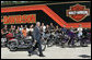 President George W. Bush is applauded as he arrives to deliver his remarks on the economy following his tour of the Harley-Davidson Vehicle Operations facility Wednesday, Aug. 16, 2006, in York, Pa. White House photo by Kimberlee Hewitt