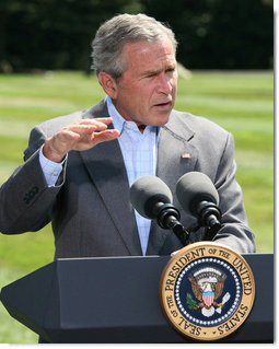 President George W. Bush gestures as he answers a reporter's question Friday, Aug. 18, 2006 in Camp David, Md., following a meeting with his economic advisors.  White House photo by Eric Draper