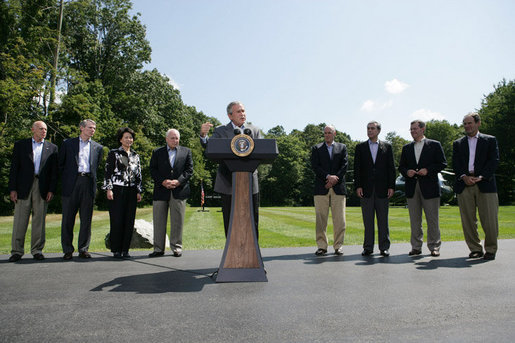 President George W. Bush gestures as he addresses his remarks to the media Friday, Aug. 18, 2006 in Camp David, Md., following a meeting with his economic advisors, from left to right, Edward P. Lazear chairman Council of Economic Advisors; Rob Portman, director of the Office of Management & Budget; U.S. Secretary of Labor, Elaine Chao; Vice President Dick Cheney; U.S. Secretary of the Treasury Henry M. Paulson; U.S. Sec. of Commerce Carlos Gutierrez; U.S. Secretary of Health & Human Services Michael O. Leavitt and Allan Hubbard, director of the National Economic Council. White House photo by David Bohrer