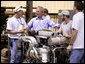 President George W. Bush visits workers at the United States Marine, Inc. boat manufacturing facility in Gulfport, Miss., Monday, Aug. 28, 2006, as part of the President’s two-day tour of the Gulf Coast region to assess the progress of the area’s recovery and rebuilding efforts following the devastation of Hurricane Katrina in 2005. White House photo by Eric Draper