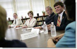 President George W. Bush and Laura Bush participate at a roundtable discussion Tuesday, Aug. 29, 2006, at Warren Easton Senior High School in New Orleans on the importance of rebuilding schools and school libraries, as the Gulf Coast marked the one- year anniversary of Hurricane Katrina. Mrs. Bush, speaking about the Laura Bush Foundation for America’s Libraries Gulf Coast School Library Recovery Initiative, congratulated the ten schools represented at the table on being awarded the first-round grants to help rebuild their schools. White House photo by Eric Draper