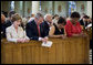 President George W. Bush and Laura Bush bow their heads in prayer Tuesday, Aug. 29, 2006, during a service at New Orleans' St. Louis Cathedral commemorating the first anniversary of Hurricane Katrina. Joining them are Ethel Williams, a 9th Ward resident, and her sister, Wanda. White House photo by Eric Draper