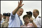 President George W. Bush waves as student Dorothy James points out other students at the Paul Hall Center for Maritime Training and Education in Piney Point, Md. Monday, September 4, 2006. White House photo by Kimberlee Hewitt