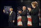 President George W. Bush acknowledges the Atlanta audience as he arrives on stage Thursday, Sept. 7, 2006, at the Cobb Galleria Centre to deliver his remarks on the global war on terror to the Georgia Public Policy Foundation. Joining the applause for the President are Georgia's Gov. Sonny Perdue and Dr. Brenda Fitzgerald, Chairman, Board of Governors, the Georgia Public Policy Foundation. White House photo by Eric Draper