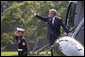 President George W. Bush waves as he prepares to depart the White House aboard Marine One from the South Lawn en route to Andrews AFB for his trip to Michigan, Friday, Sept. 8, 2006. White House photo by Eric Draper