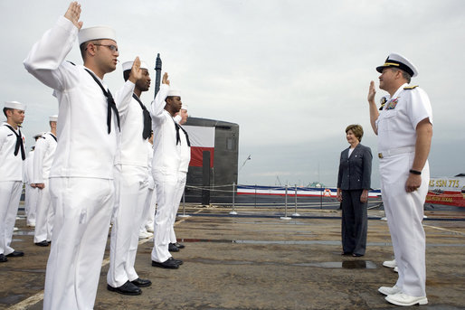 Mrs. Laura Bush observes a U.S. Navy Re-enlistment Ceremony Saturday, September 9, 2006, as Rear Admiral Fox, Director, White House Military Office, administers the oath to sailors prior to the Commissioning Ceremony of the USS Texas in Galveston, Texas. White House photo by Shealah Craighead