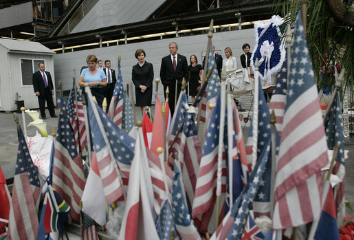 During their visit to Ground Zero, President George W. Bush and Laura Bush look at a memorial created from some of the objects visitors have brought to the site in New York City Sunday, September 10, 2006. White House photo by Eric Draper