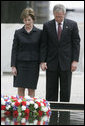 President George W. Bush and Laura Bush stand in silence after laying a wreath in the north reflecting pool at Ground Zero September 10, 2006, in commemoration of the fifth anniversary of the terrorist attacks of September 11, 2001, on the World Trade Center in New York City. White House photo by Kimberlee Hewitt